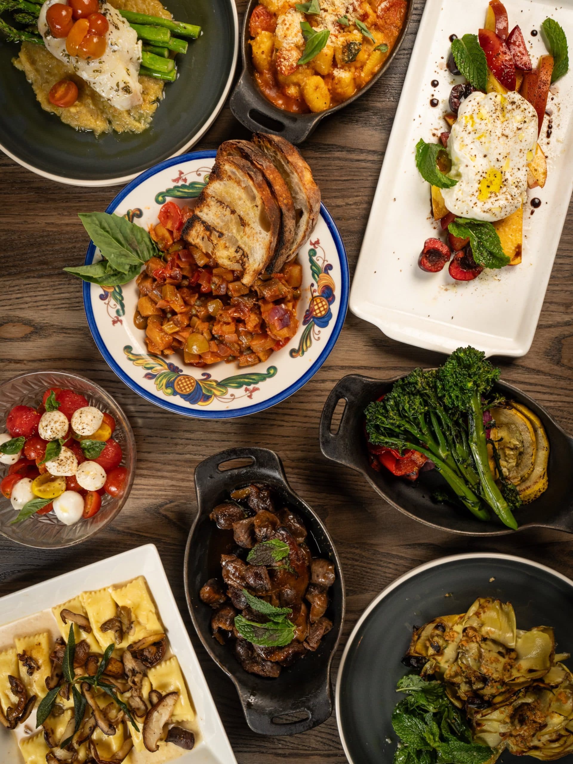 A spread of Sicilian dishes across the table at Monzú
